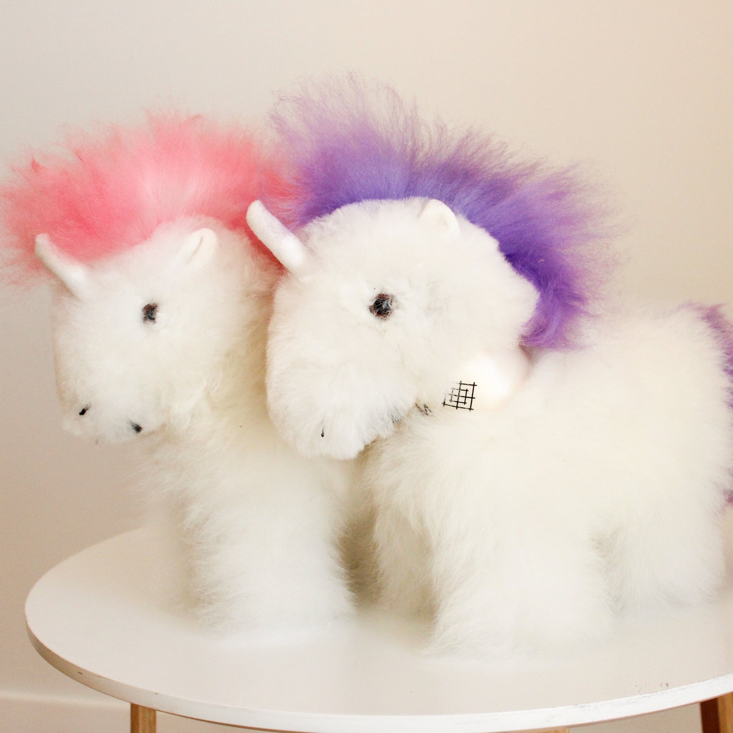 Alpaca wool unicorn plushie gift or home decoration. 100% baby  
alpaca wool. Handmade by Bolivian and Peruvian artisans. Pink and purple stuffed unicorn