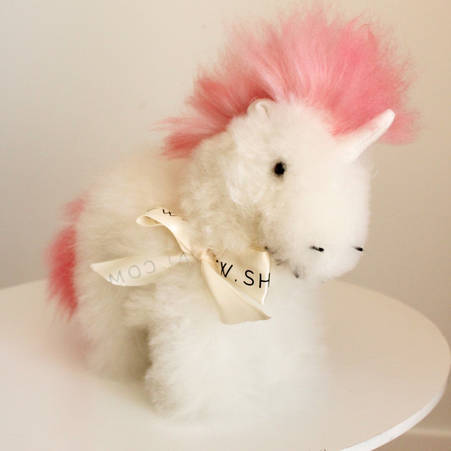 Alpaca wool unicorn plushie gift or home decoration. 100% baby  
alpaca wool. Handmade by Bolivian and Peruvian artisans. Pink stuffed unicorn