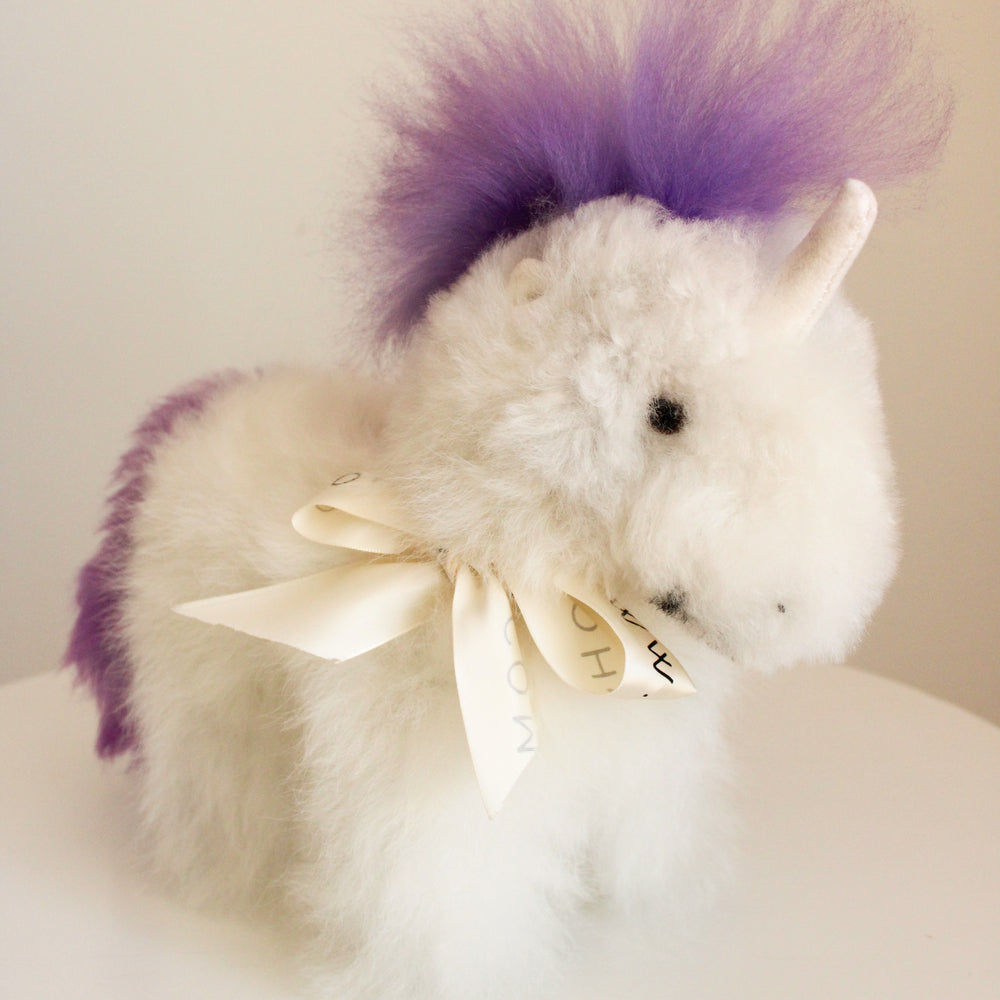 
                      
                        Alpaca wool unicorn plushie gift or home decoration. 100% baby  
alpaca wool. Handmade by Bolivian and Peruvian artisans. Purple lilac stuffed unicorn
                      
                    