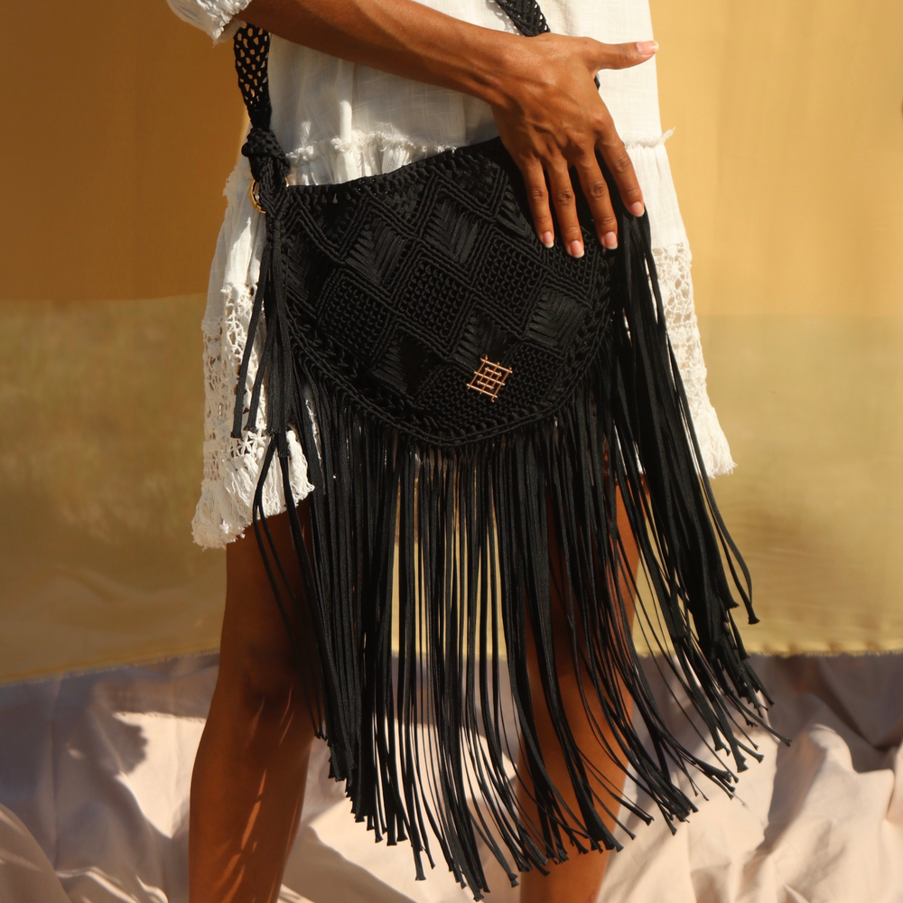 
                      
                        Black Macrame crossbody bag with fringes. Includes lining and zipper. Handmade in Bolivia. Hand Wash and professional cleaning only. 100% Rayon
                      
                    