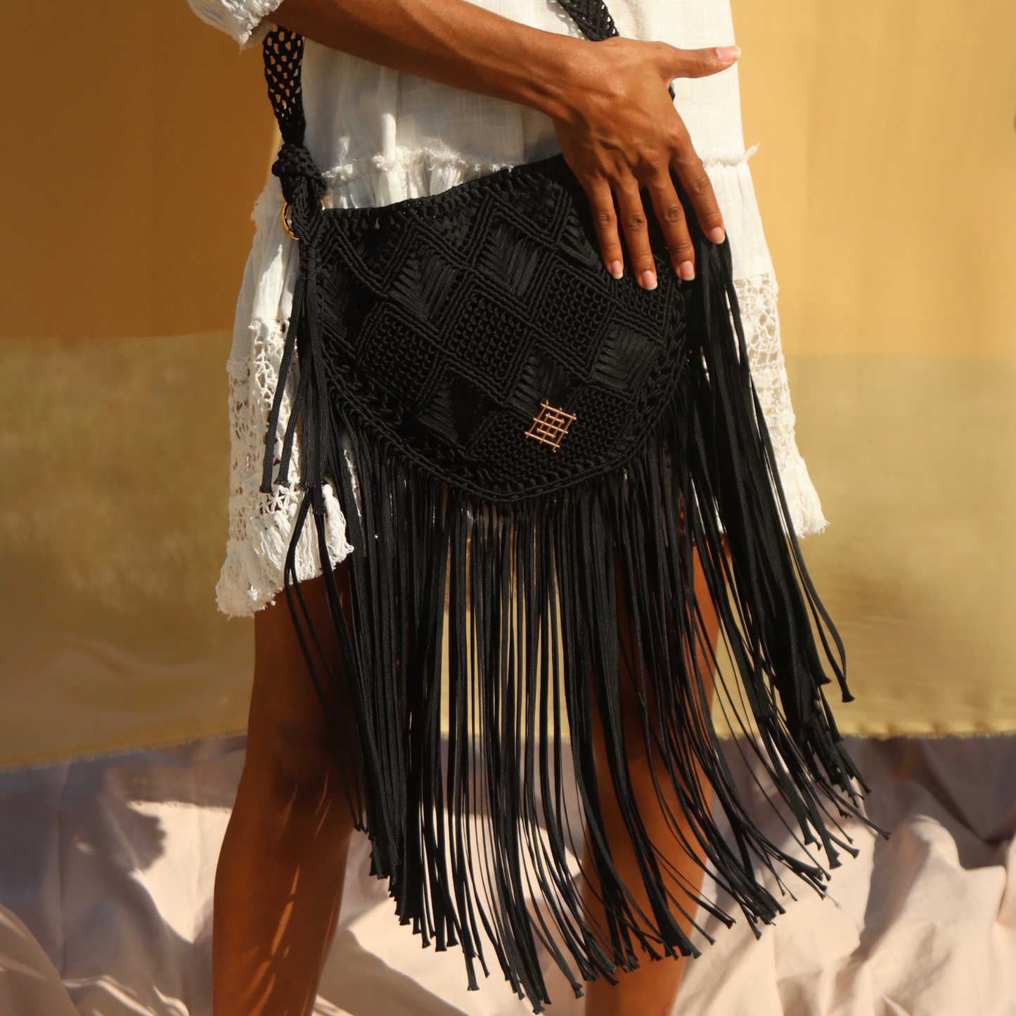 Black Macrame crossbody bag with fringes. Includes lining and zipper. Handmade in Bolivia. Hand Wash and professional cleaning only. 100% Rayon