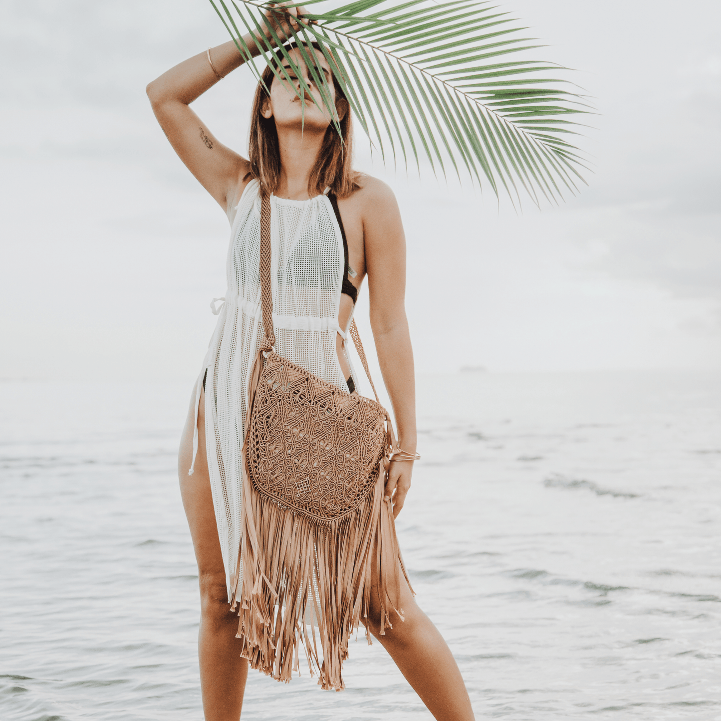 Gold Macrame crossbody bag with fringes. Includes lining and zipper. Handmade in Bolivia. Hand Wash and professional cleaning only. 100% Rayon