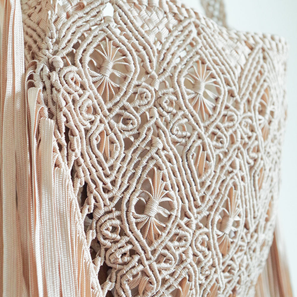 
                      
                        Beige Macrame crossbody bag with fringes. Includes lining and zipper. Handmade in Bolivia. Hand Wash and professional cleaning only. 100% Rayon
                      
                    