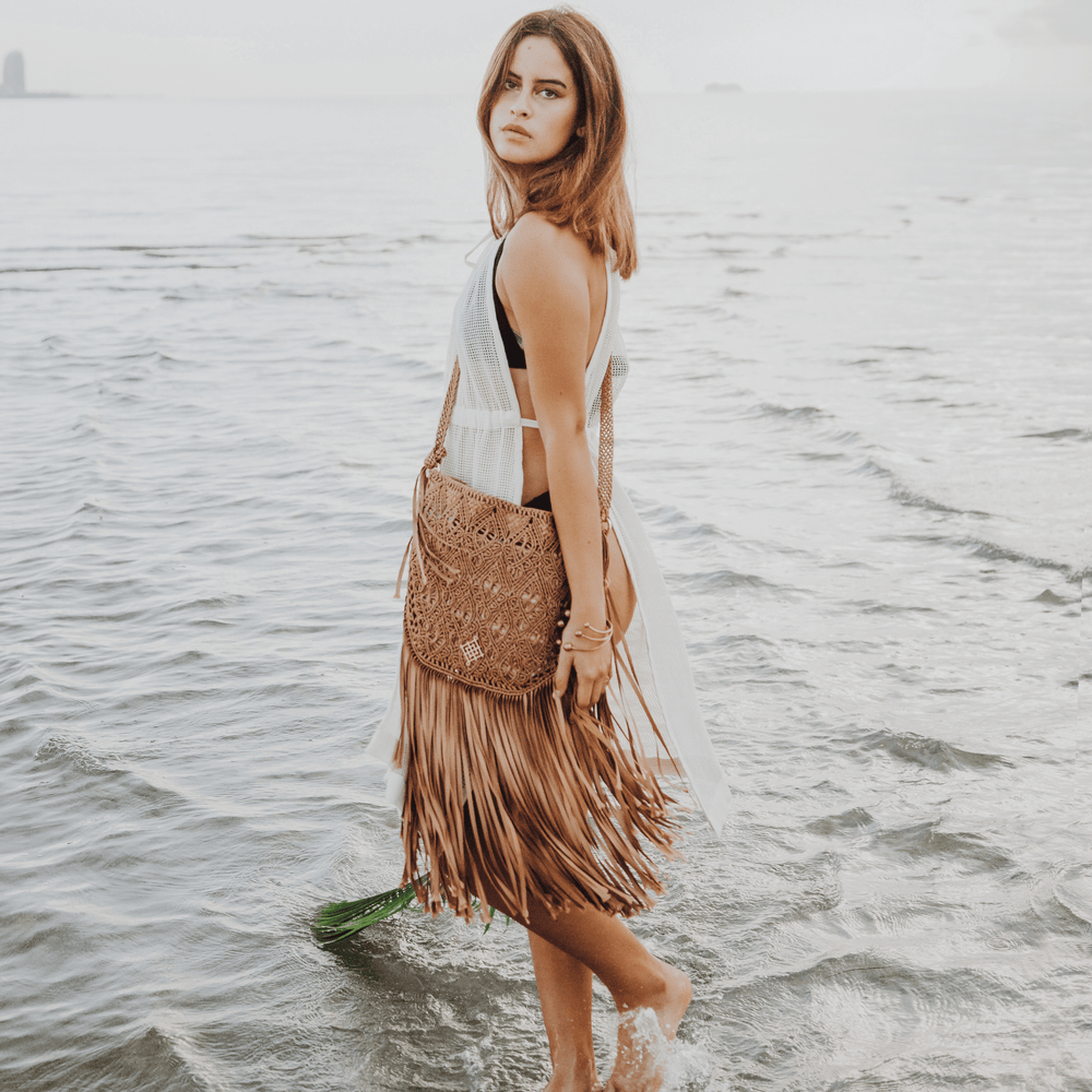 
                      
                        Macrame crossbody bag with fringes. Color: Light Brown. Includes lining and zipper. Handmade in Bolivia. Hand Wash and professional cleaning only. 100% Rayon
                      
                    