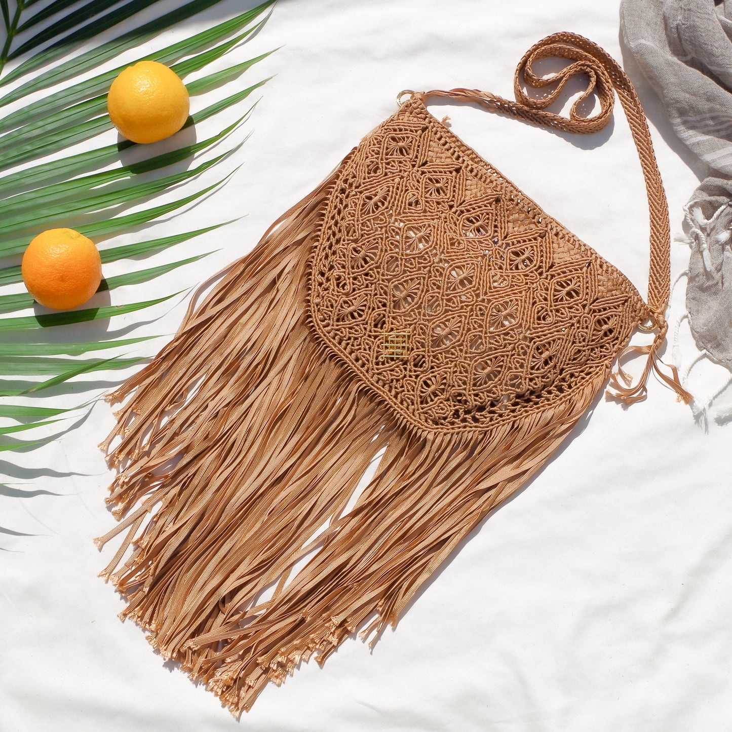 Macrame crossbody bag with fringes. Includes lining and zipper. Handmade in Bolivia. Hand Wash and professional cleaning only. 100% Rayon