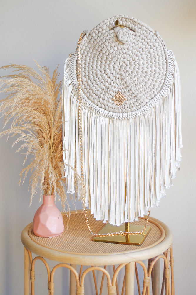 
            
                Load image into Gallery viewer, Rounded crossbody bag with fringes and chain strap. Made with crochet and macrame techniques. Boho Style. Color: Sand. Includes lining and zipper. Handmade in Bolivia. Hand Wash and professional cleaning only. 100% Rayon
            
        
